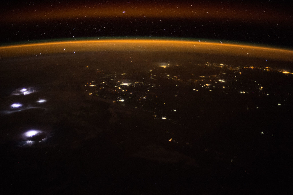 Earth Observations of Lightning in the Clouds at Night with Golden Aurora